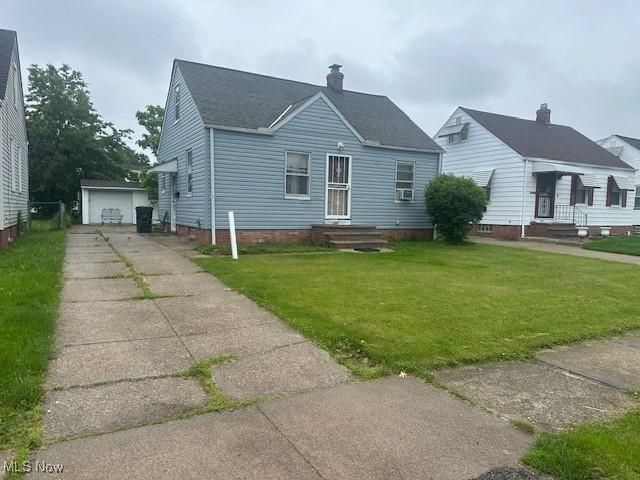 20371 Morris Ave, Euclid, OH 44123 - bungalow featuring a front yard, a garage, an outdoor structure, and roof with shingles