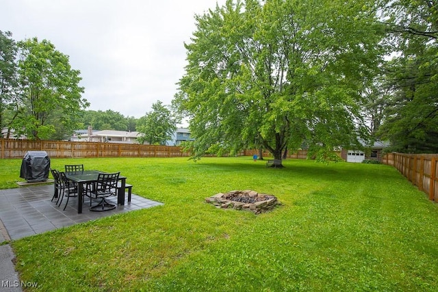 2611 E Pleasant Valley Rd, Seven Hills, OH 44131 - fenced backyard featuring a patio area and an outdoor fire pit