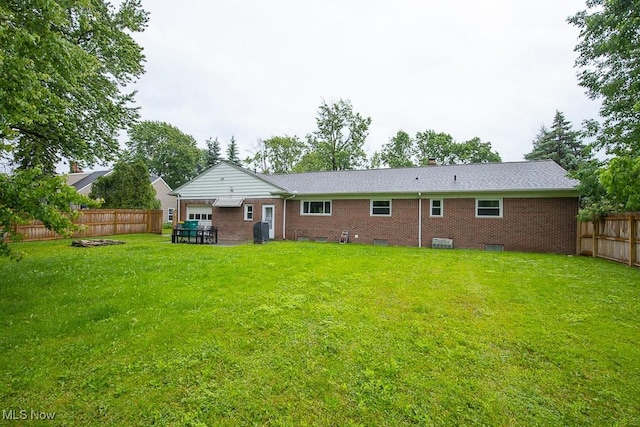 2611 E Pleasant Valley Rd, Seven Hills, OH 44131 - back of property featuring a fenced backyard, brick siding, and crawl space
