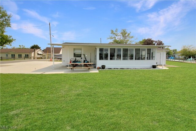 1660 N Compass Ave, Port Clinton, OH 43452 - rear view of property featuring a patio and a sunroom