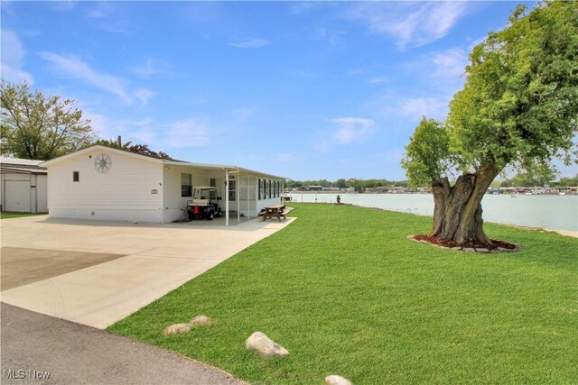 1660 N Compass Ave, Port Clinton, OH 43452 - view of green lawn featuring a water view and driveway