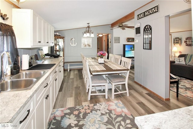 1660 N Compass Ave, Port Clinton, OH 43452 - kitchen with light wood-style flooring, white cabinets, ceiling fan, and light countertops