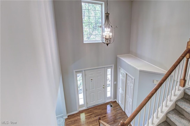 881 Brightwood Ct, Brunswick, OH 44212 - entrance foyer featuring a chandelier, wood finished floors, a high ceiling, and stairs