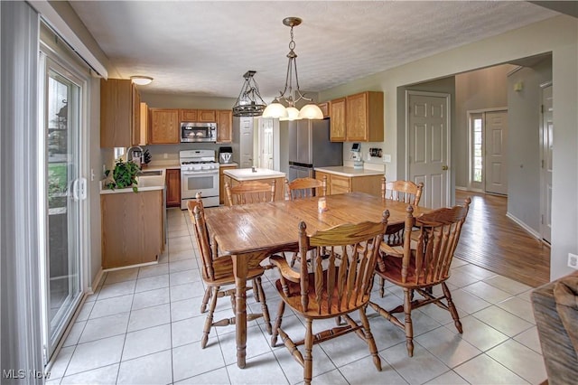 881 Brightwood Ct, Brunswick, OH 44212 - dining space featuring light tile patterned floors and a chandelier