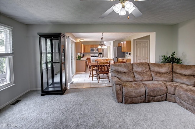 881 Brightwood Ct, Brunswick, OH 44212 - living room with light carpet, a ceiling fan, and a textured ceiling