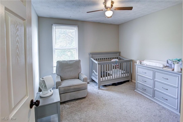 881 Brightwood Ct, Brunswick, OH 44212 - carpeted bedroom with a textured ceiling, a nursery area, and ceiling fan
