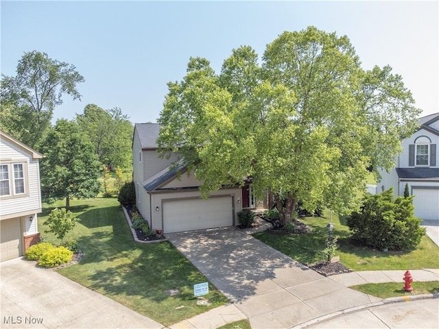 881 Brightwood Ct, Brunswick, OH 44212 - view of property hidden behind natural elements with a garage, a front lawn, and concrete driveway