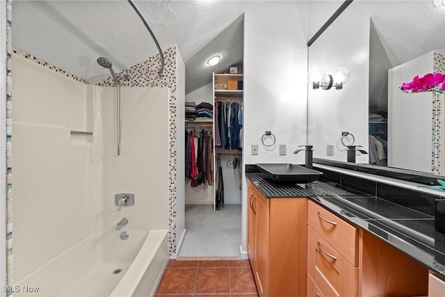 1345 Mockingbird Dr, Kent, OH 44240 - full bathroom with a textured ceiling,  shower combination, vanity, tile patterned floors, and a walk in closet