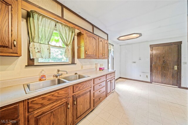 5769 Hurlburt Rd, Rome, OH 44085 - kitchen featuring brown cabinetry, light countertops, and light floors