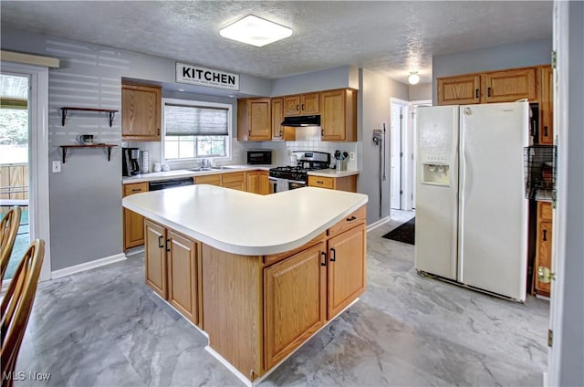 2121 Laurel Ln, Streetsboro, OH 44241 - kitchen with white fridge with ice dispenser, stainless steel gas range, under cabinet range hood, light countertops, and a kitchen island