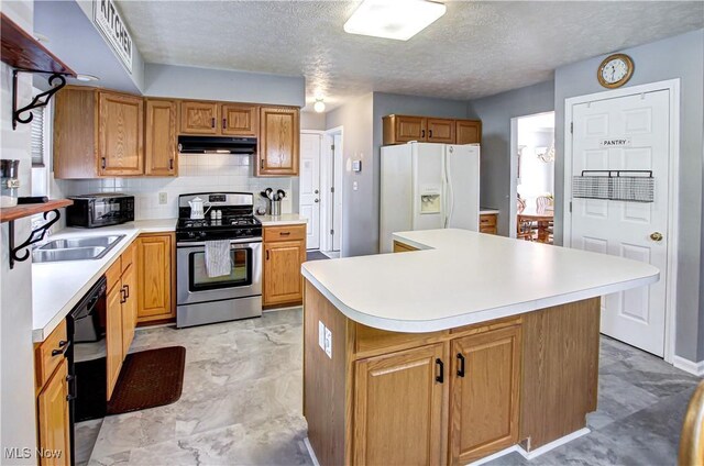 2121 Laurel Ln, Streetsboro, OH 44241 - kitchen featuring stainless steel range with gas stovetop, white fridge with ice dispenser, under cabinet range hood, light countertops, and a textured ceiling