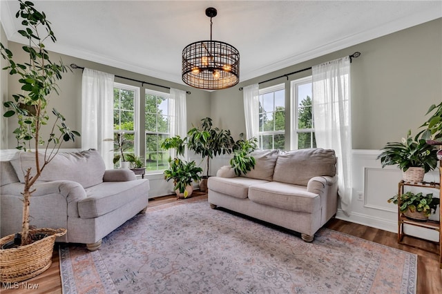 4532 Ridgestone Way, Medina, OH 44256 - living area featuring a chandelier, ornamental molding, wood finished floors, and a wainscoted wall