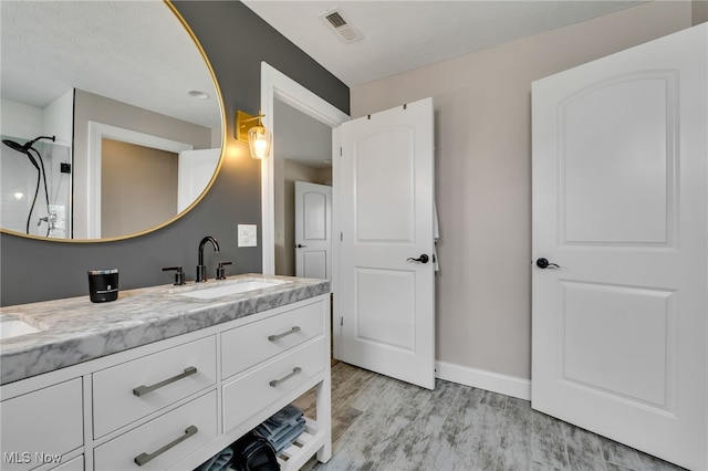 4532 Ridgestone Way, Medina, OH 44256 - full bathroom with double vanity, wood finished floors, and a shower