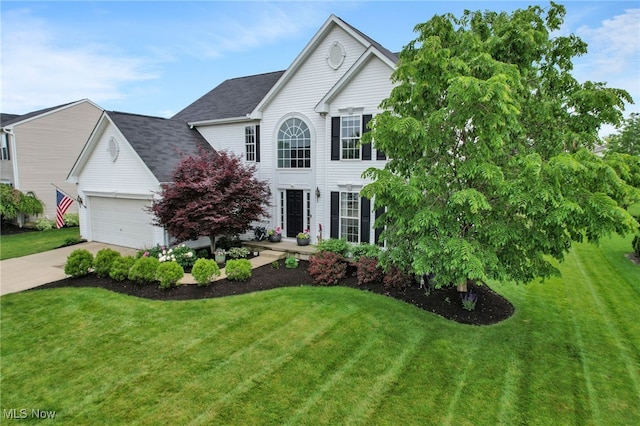 4532 Ridgestone Way, Medina, OH 44256 - colonial inspired home with a front yard, driveway, a garage, and roof with shingles