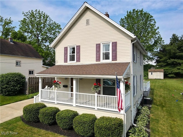 26 Walnut Ct, Mogadore, OH 44260 - view of front of property featuring a porch, a front yard, a shed, a chimney, and a shingled roof