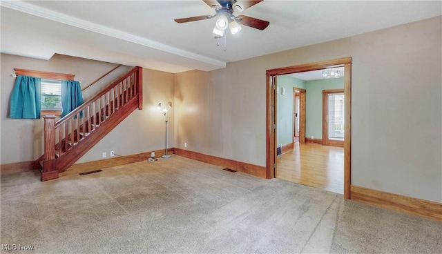 26 Walnut Ct, Mogadore, OH 44260 - unfurnished living room featuring carpet, healthy amount of natural light, stairs, and a ceiling fan