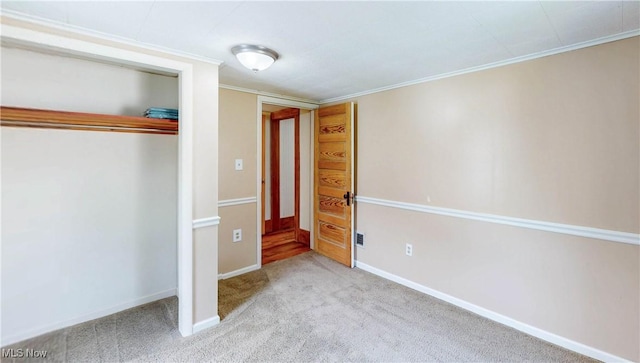 26 Walnut Ct, Mogadore, OH 44260 - unfurnished bedroom with carpet floors, ornamental molding, and a closet