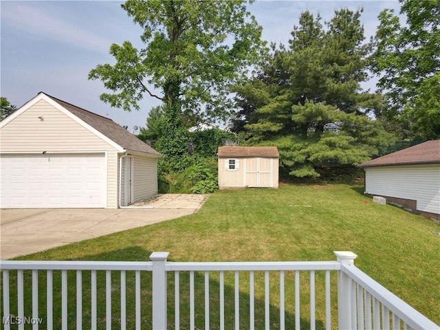26 Walnut Ct, Mogadore, OH 44260 - view of grassy yard with a shed and a detached garage