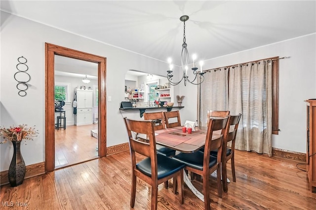 1754 Edgewood St NE, Warren, OH 44483 - dining area with a chandelier, hardwood / wood-style flooring, and arched walkways