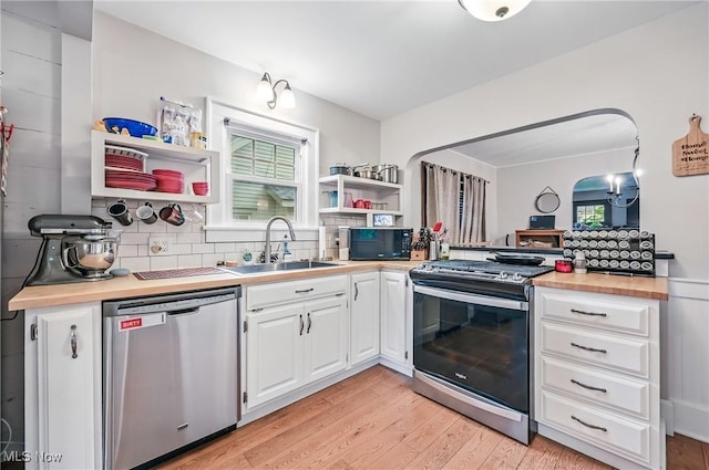 1754 Edgewood St NE, Warren, OH 44483 - kitchen with appliances with stainless steel finishes, open shelves, plenty of natural light, and white cabinetry