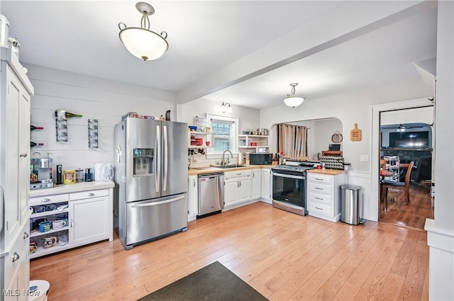 1754 Edgewood St NE, Warren, OH 44483 - kitchen with stainless steel appliances, light wood finished floors, light countertops, and white cabinets