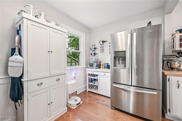 1754 Edgewood St NE, Warren, OH 44483 - kitchen featuring stainless steel refrigerator with ice dispenser, light wood-type flooring, white cabinets, and light countertops