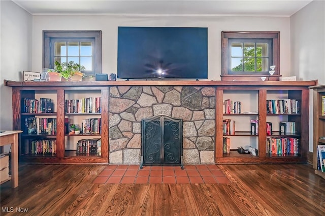 1754 Edgewood St NE, Warren, OH 44483 - unfurnished living room featuring wood finished floors, plenty of natural light, crown molding, and a stone fireplace