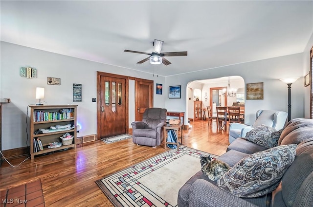 1754 Edgewood St NE, Warren, OH 44483 - living room with arched walkways, wood finished floors, ceiling fan, and a chandelier