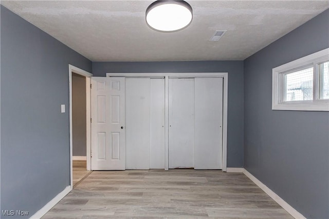 12604 Saint John Ave, Cleveland, OH 44111 - unfurnished bedroom with a closet and wood finished floors
