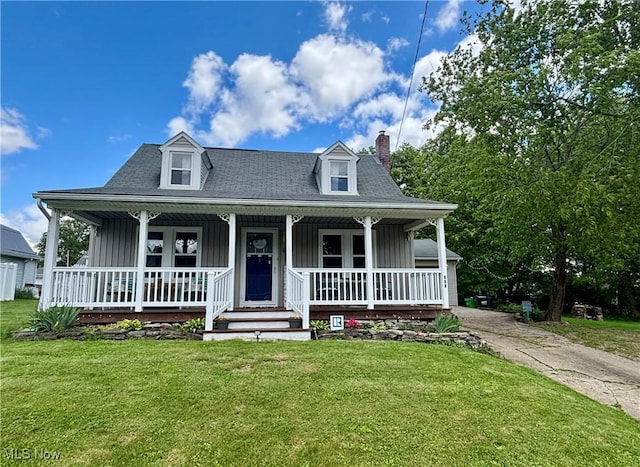 967 Lincoln St, Wooster, OH 44691 - view of front of house featuring board and batten siding, a chimney, covered porch, and a front lawn