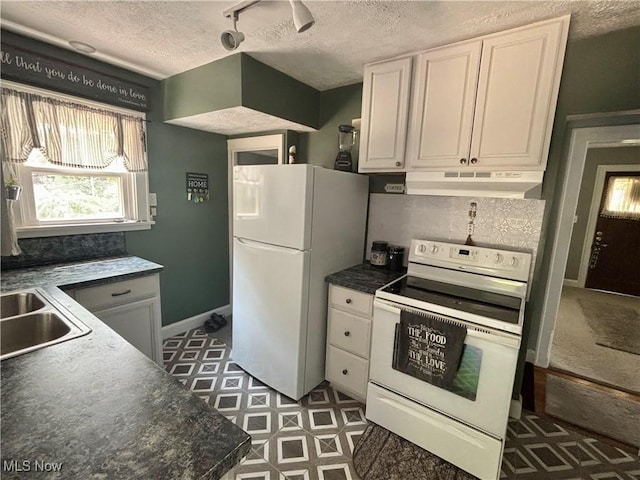 967 Lincoln St, Wooster, OH 44691 - kitchen featuring white appliances, under cabinet range hood, a textured ceiling, white cabinets, and dark countertops