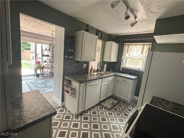 967 Lincoln St, Wooster, OH 44691 - kitchen featuring white appliances, track lighting, a textured ceiling, plenty of natural light, and dark countertops