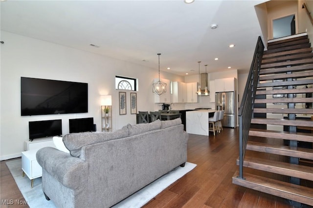 604 Marquardt Ave, Cleveland, OH 44113 - living room with stairs, recessed lighting, dark wood-style flooring, and a chandelier