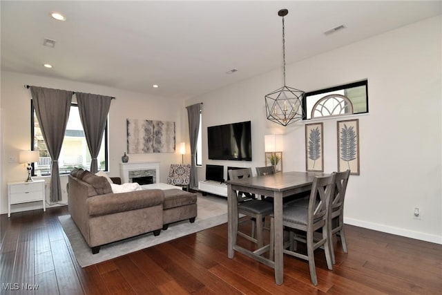 604 Marquardt Ave, Cleveland, OH 44113 - dining area featuring dark wood-style floors, a fireplace, recessed lighting, and a chandelier