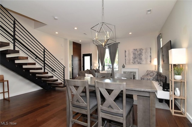 604 Marquardt Ave, Cleveland, OH 44113 - dining room featuring stairs, dark wood-style flooring, a chandelier, and recessed lighting