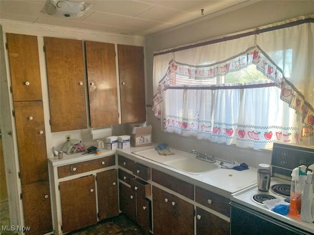 2005 Liberty Rd, Stow, OH 44224 - kitchen with white electric stove, light countertops, crown molding, and brown cabinetry