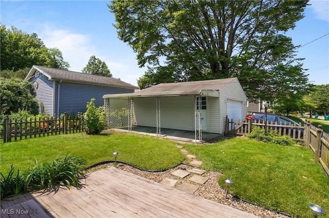 608 S 14th St, Sebring, OH 44672 - fenced backyard featuring a wooden deck, an outbuilding, and a detached garage