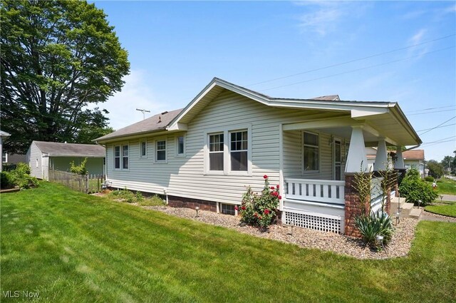 608 S 14th St, Sebring, OH 44672 - view of side of home featuring a porch and a lawn