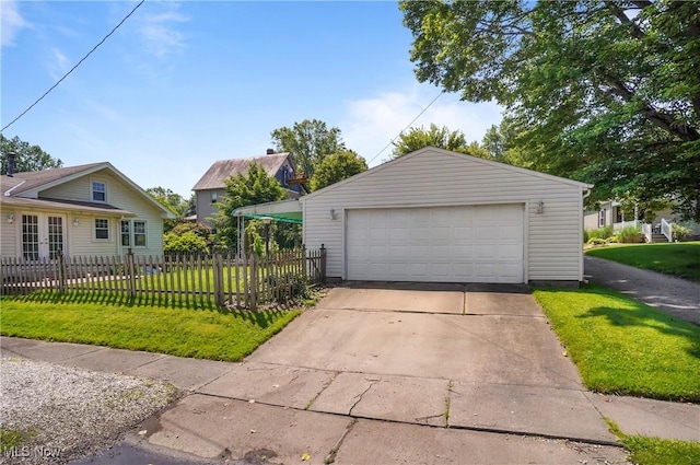 608 S 14th St, Sebring, OH 44672 - view of front of house with a detached garage, french doors, and an outbuilding