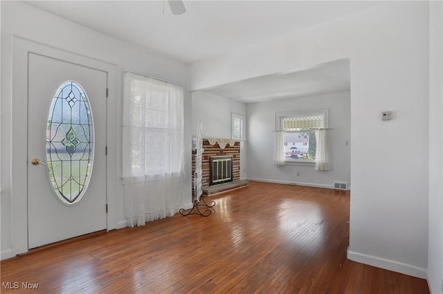 608 S 14th St, Sebring, OH 44672 - foyer with wood-type flooring, ceiling fan, and a fireplace