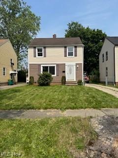 5357 Beechwood Ave, Maple Heights, OH 44137 - view of front facade with a front yard, entry steps, and a chimney