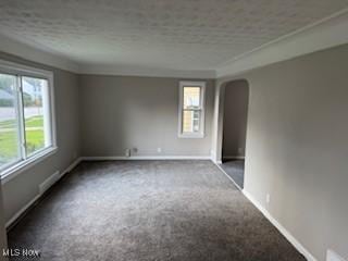 5357 Beechwood Ave, Maple Heights, OH 44137 - spare room featuring arched walkways and carpet floors