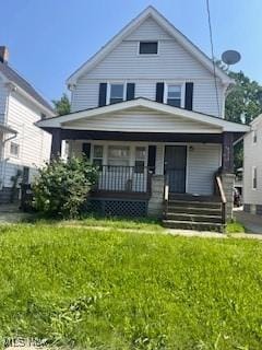 4313 Wichita Ave, Cleveland, OH 44109 - american foursquare style home with a porch and a front lawn