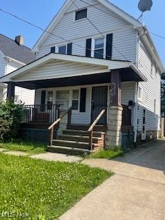 4313 Wichita Ave, Cleveland, OH 44109 - traditional style home with covered porch, driveway, and a front lawn