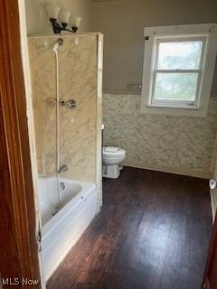 4313 Wichita Ave, Cleveland, OH 44109 - bathroom with wood finished floors, a wainscoted wall, and shower / washtub combination