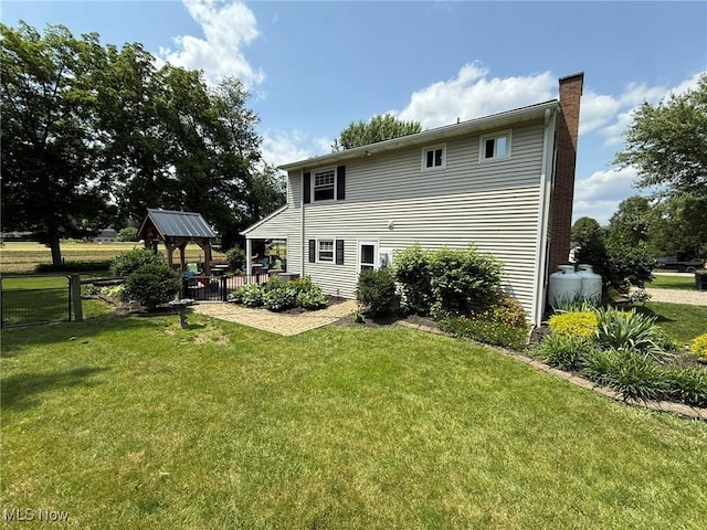 22399 Township Rd Unit 1203, West Lafayette, OH 43845 - rear view of house with a chimney, a gazebo, and a patio area