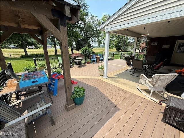 22399 Township Rd Unit 1203, West Lafayette, OH 43845 - deck featuring outdoor dining space and a lawn