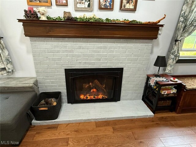 22399 Township Rd Unit 1203, West Lafayette, OH 43845 - detailed view of a brick fireplace and wood finished floors