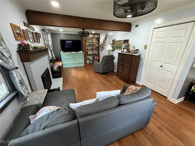 22399 Township Rd Unit 1203, West Lafayette, OH 43845 - living area featuring ornamental molding, beam ceiling, wood finished floors, a tiled fireplace, and recessed lighting