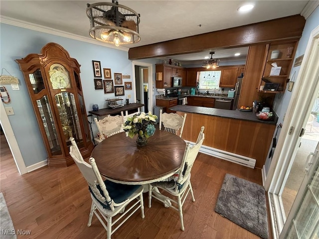 22399 Township Rd Unit 1203, West Lafayette, OH 43845 - dining room with wood finished floors, a chandelier, baseboard heating, crown molding, and recessed lighting
